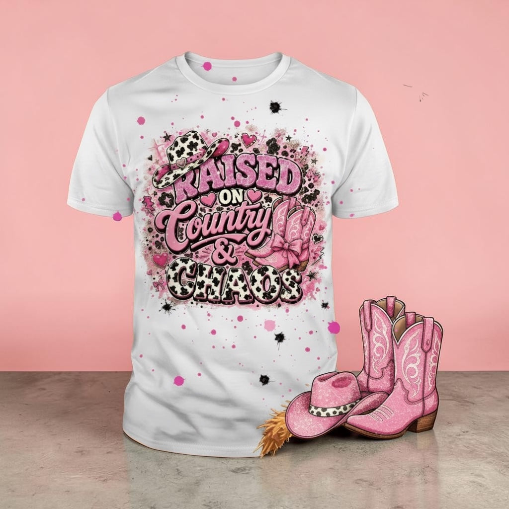 White t-shirt with pink and black graphic design, pink cowboy boots, and hat on a pink background