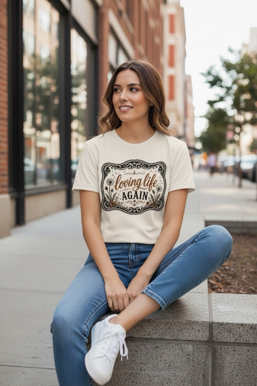 Southern Charm Design Works cream graphic t-shirt with vintage dandelion frame worn by a woman with blue jeans.